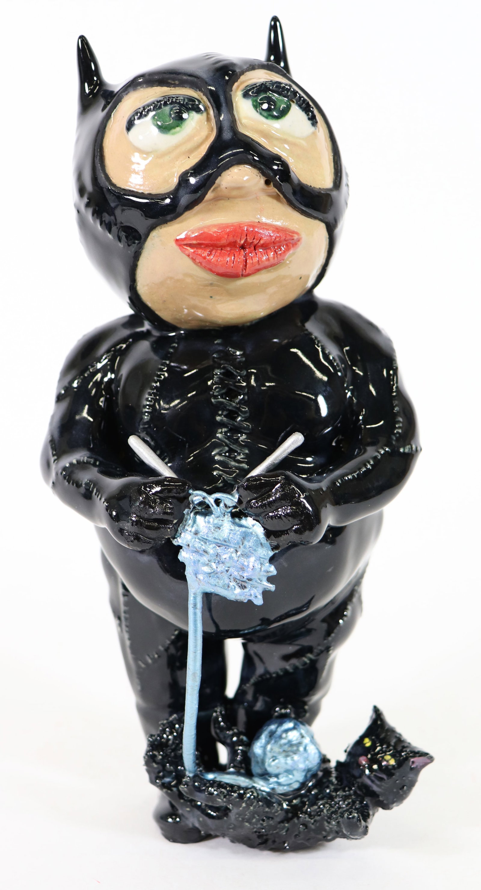 JEREMY WARDELL CATWOMAN KNITTING SCULPTURE: Jeremy Wardell Folk Art pottery sculpture of a whimsical Catwoman figure knitting and a cat playing with the ball of yarn. Catwoman is modeled after the Michelle Pfeiffer character in Batman Returns (