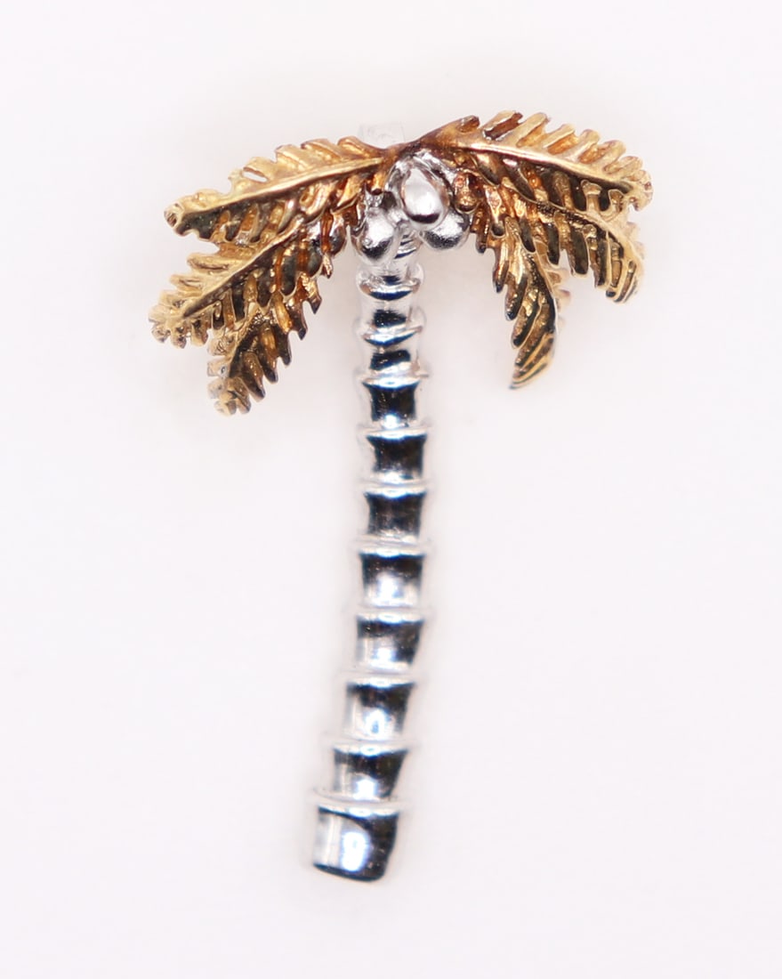 14K & STERLING SILVER COCONUT PALM TREE PENDANT: Coconut palm tree pendant crafted in sterling silver with 14KT yellow gold palms. Measures 1 1/4" long and weighs 3 grams.