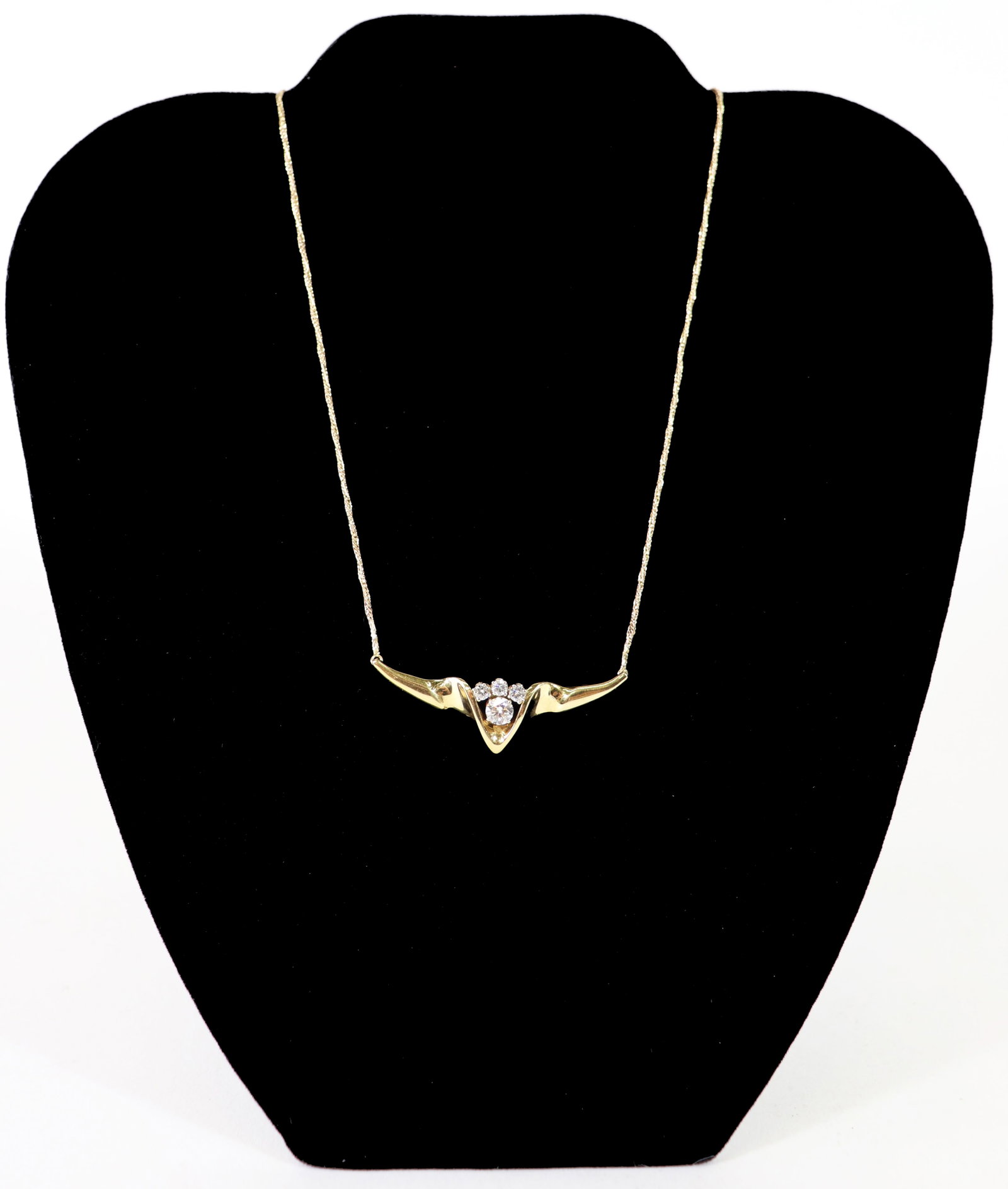 14K GOLD DIAMOND ANGEL WINGS PENDANT: A 14K yellow gold necklace with a 16" chain. There are 3 sparkling round diamonds to include a .50 carat with (3) .15 carat diamonds set in an angel wing pendant. Total weight 8.9 g / 5.7 dwt