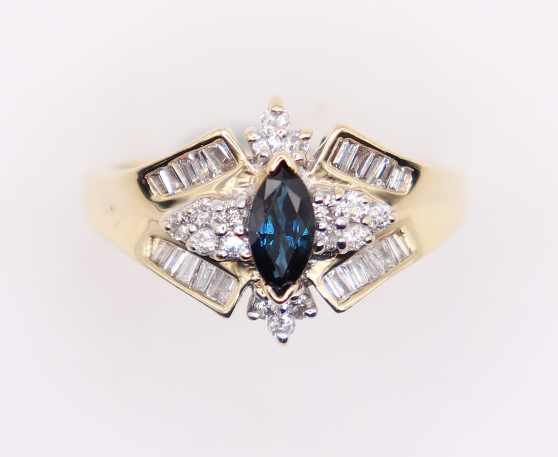 14K DIAMOND & SAPPHIRE RING: 14KT yellow gold ring with marquise cut blue sapphire accented with round and baguette diamonds. Size 8 1/4, weighs 5 grams.