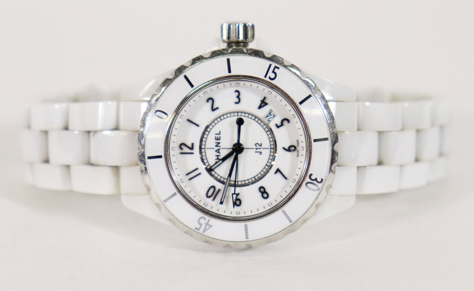 CHANEL J12 CERAMIC WRISTWATCH: A Chanel watch from the J12 collection 34mm Case, Stainless Steel & Ceramic Quartz Movement with Date Complication, Smooth unidirectional rotating & coin bezel, White Dial, Butterfly Clasp Fits a 7" o