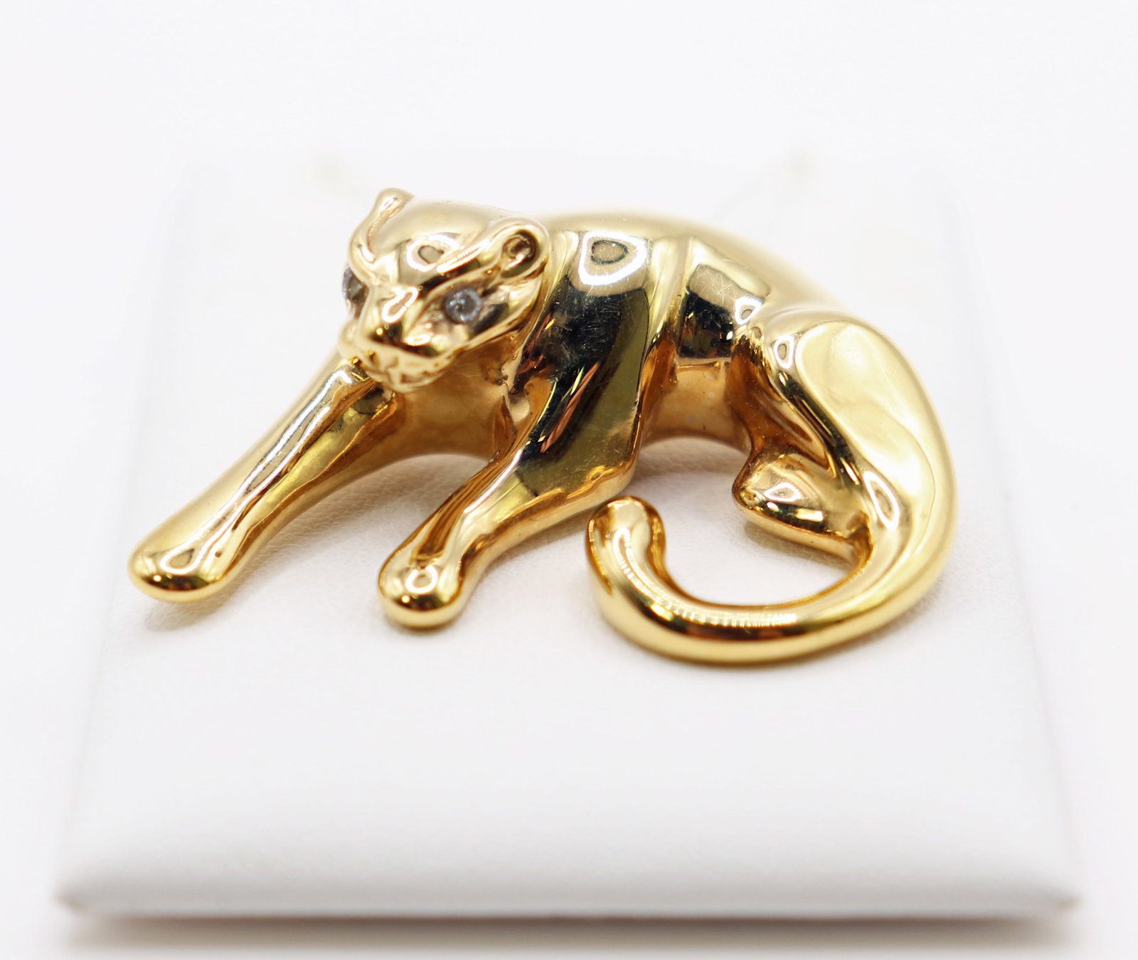 14K YELLOW GOLD CAT PENDANT WITH DIAMOND EYES: 14KT Yellow gold laying cat / panther pendant with diamond accented eyes. Measures 1.5" wide 1" tall and weighs 4 grams ( 2.5 DWT).