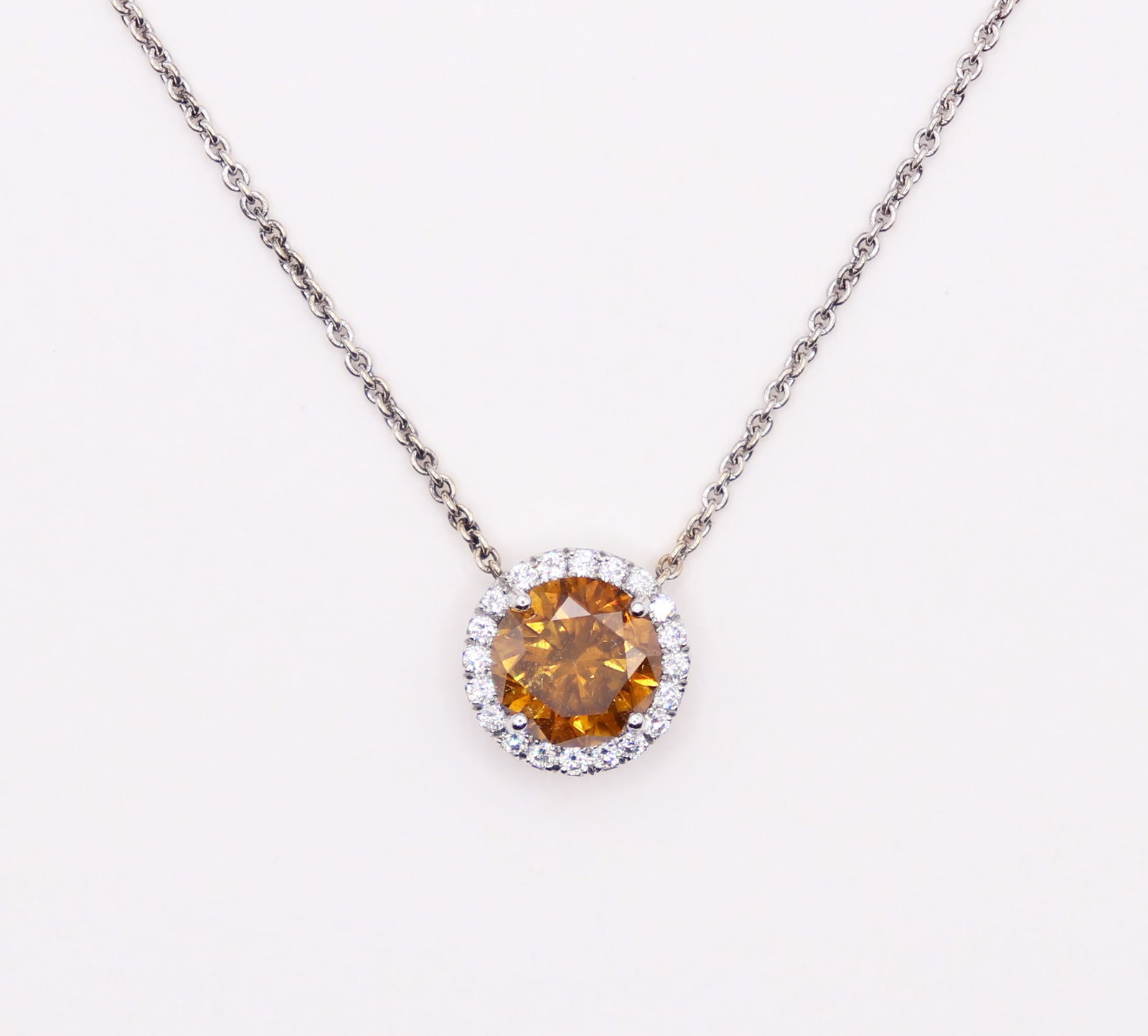 18K FANCY ORANGE 1.90 CT DIAMOND NECKLACE - GIA: A round brilliant 1.90 carat natural fancy deep brownish yellowish orange diamond (7.73 - 7.81 x 4.93 mm) set in platinum with an 18K white gold 15" chain. It comes with a GIA report. It was purchased