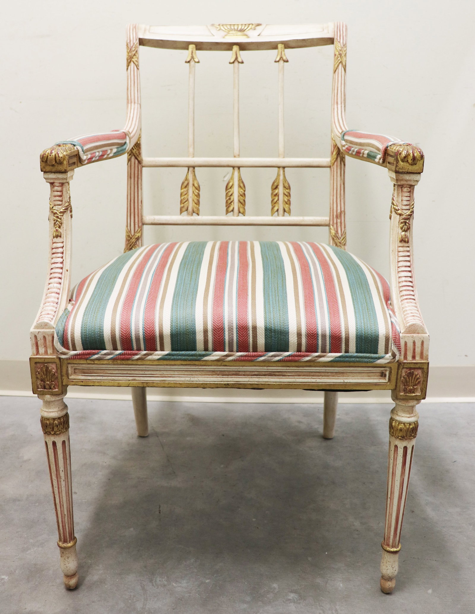 GUSTAVIAN STYLE ARMCHAIR: Unusual French / Gustavian style arm chair with arrow back, shell, and urn accents. Measures 37" tall to back, 22" x 20" wide.