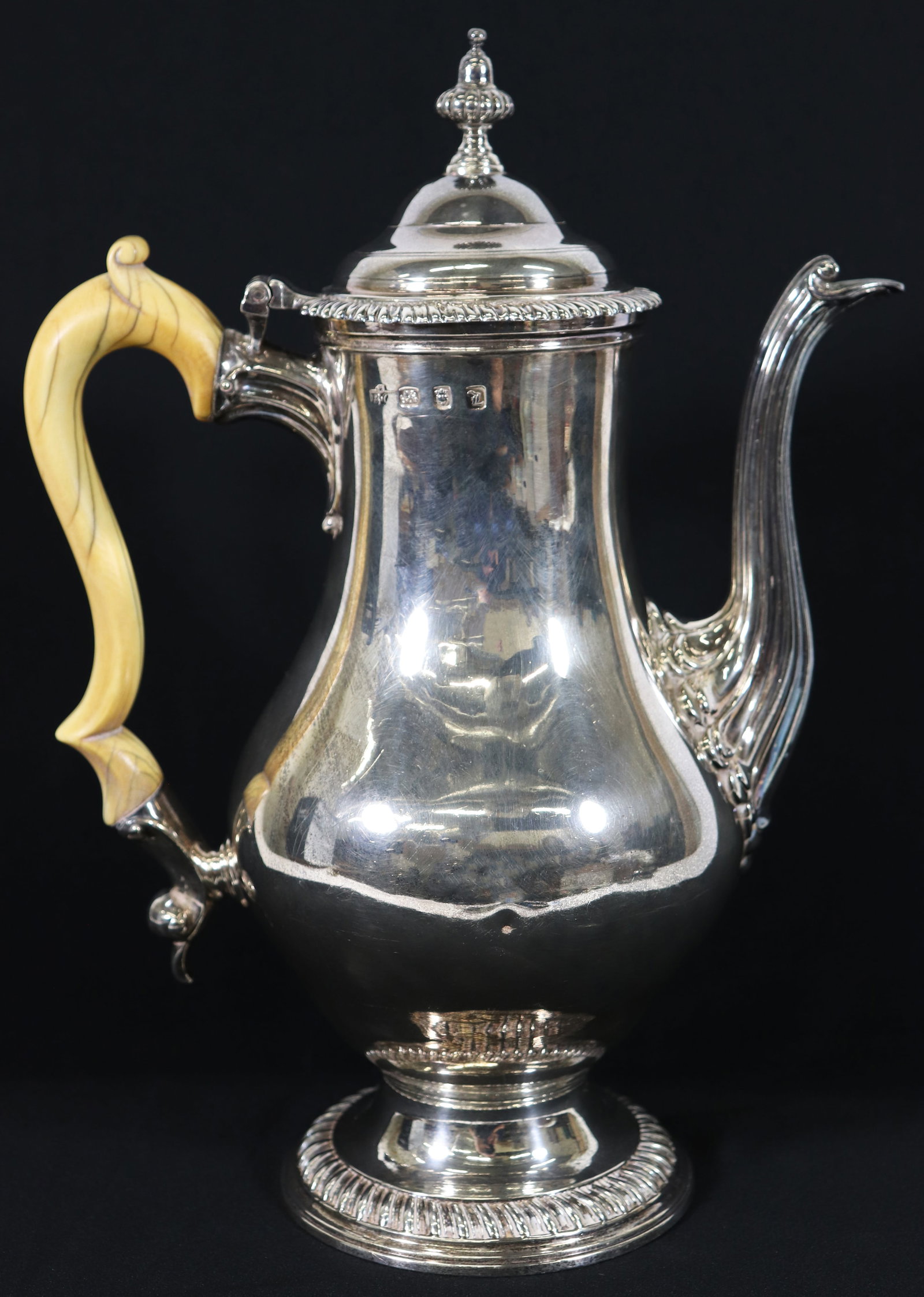 18TH CENTURY GEORGIAN STERLING SILVER COFFEE POT: Circa 1776 London England sterling silver hallmarked coffee pot. Slight indentations. Measures 12" tall, 9" wide and weighs 42.4 OZT (1321 grams).
