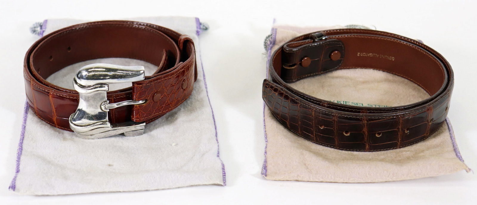 KIESELSTEIN-CORD STERLING BUCKLE W/ 2 BELTS: A 1986 Barry Kieselstein Cord sterling silver buckle (2.75" wide) with 2 genuine alligator marked B. Kieselstein Cord New York belts (1.5" wide). One is a brown belt 37.5" long and a dark brown belt