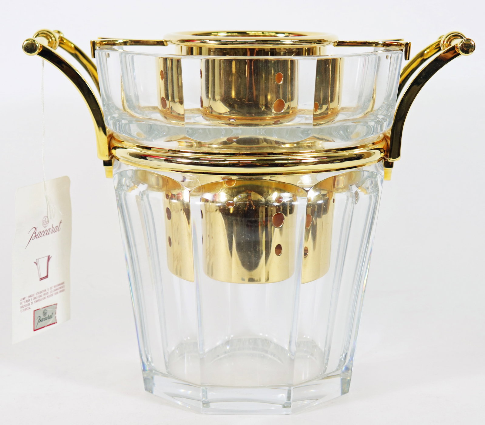 BACCARAT HARCOURT CHAMPAGNE COOLER W/ BOX: Baccarat Crystal Harcourt champagne cooler bucker with original box. Crystal cooler has two gold handles and gold insert. Measures 9" tall 11" x 7.5" wide. Includes original box.