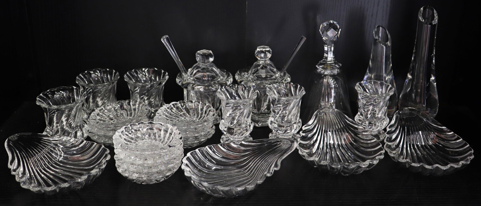 (25) PIECES BACCARAT GLASS COLLECTION: An assortment of signed Baccarat glass to include (4) shell dishes, (2) covered condiment jelly jars with spoons, (2) bud vases, (10) nut dishes, a bell, (3) toothpick holders and (3) spoon holders. S