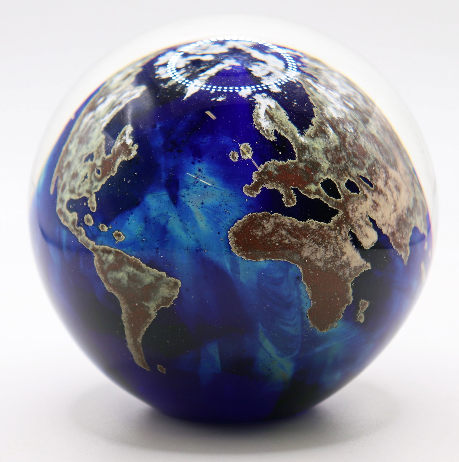 LUNDBERG STUDIOS "WORLD" ART GLASS PAPERWEIGHT: Lundberg Studios "World" globe glass paperweight , numbered 08/915, measures 3 1/3" x 31/4" , marked 2019 and signed on bottom.