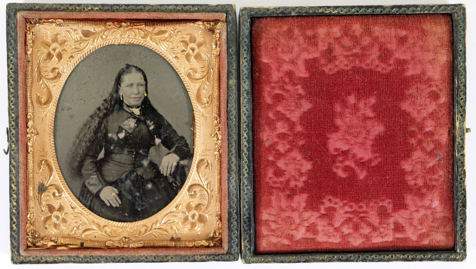 CIVIL WAR ERA DAGUERREOTYPE - SEATED WOMAN: A 19th century daguerreotype of a woman with long hair in a seated pose. It is in a period frame case with a gilt frame. 3.5" x 3.25". Age related wear. Provenance: From the estate of Antonio Tanco.