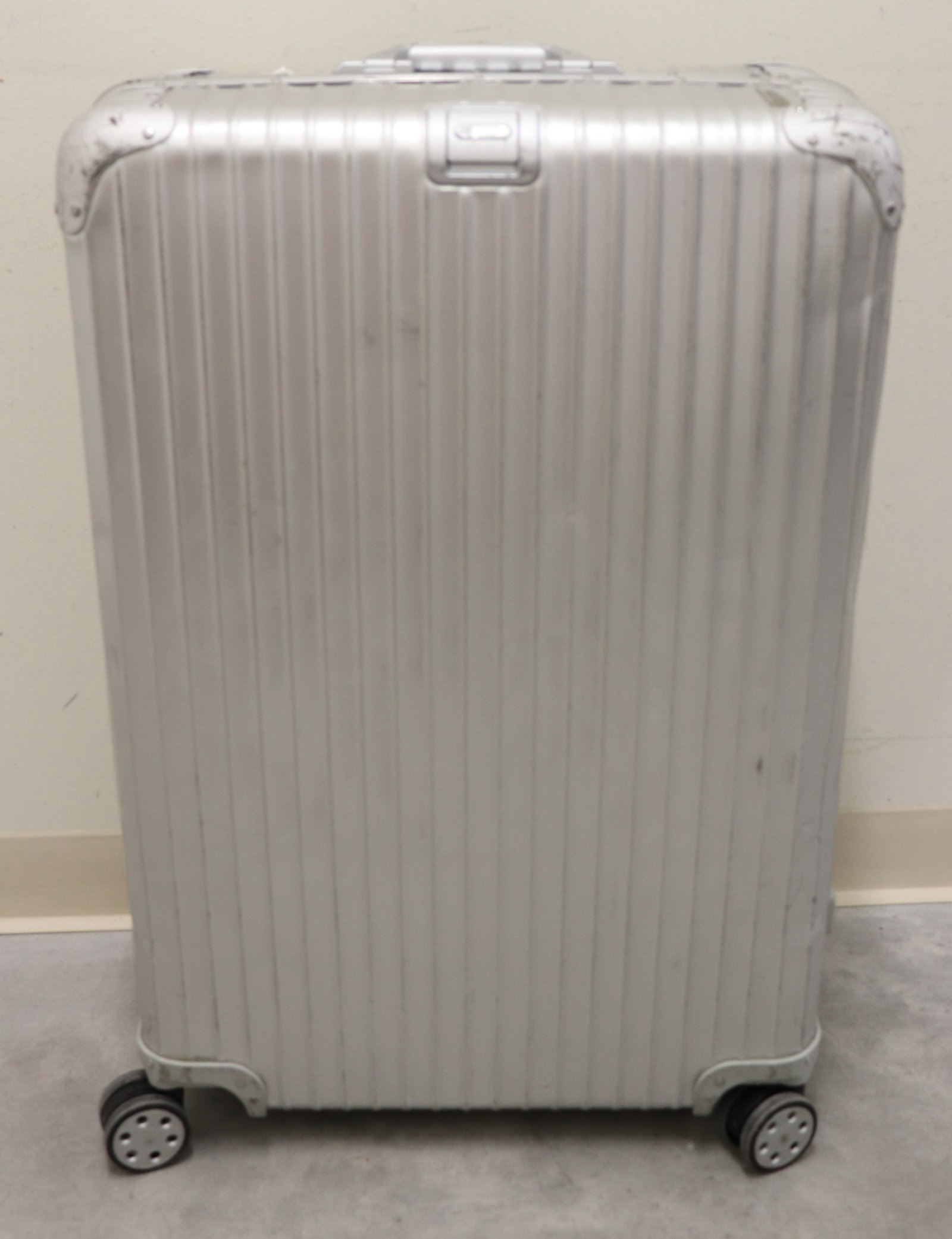 RIMOWA ORIGINAL LARGE ALUMINUM SUITCASE 31": A Rimowa large check in aluminum suitcase with multi-wheel (spinner) wheel system. Measures approximately 3" x20" 10.5". Made in Canada. Numbered 9207700402/0421515. Age related wear, exterior scuffs,
