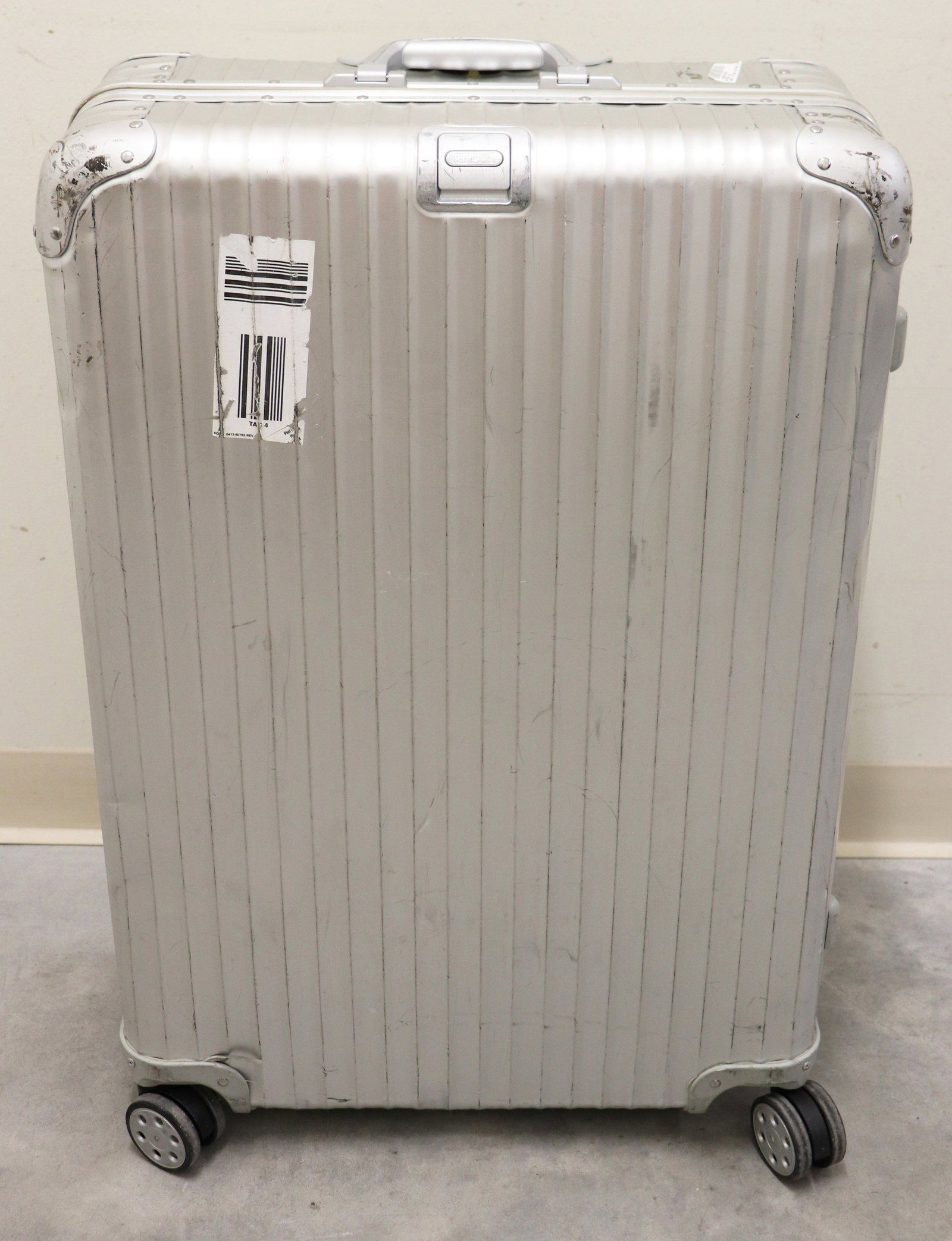 RIMOWA ORIGINAL LARGE ALUMINUM SUITCASE 31": A Rimowa large check in aluminum suitcase with multi-wheel (spinner) wheel system. Measures approximately 31" x 20" x10". Made in Canada. Numbered 9327701204468. Age related wear, exterior scuffs, kni