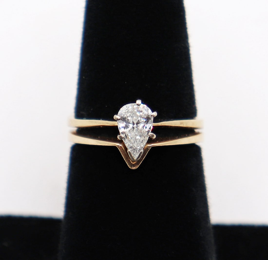 14K PEAR SHAPE DIAMOND RING AND BAND: 14KT yellow gold ring with an approximate .70 carat pear shape diamond and "V" shape band. Total weight 5 grams. Ring size 6.