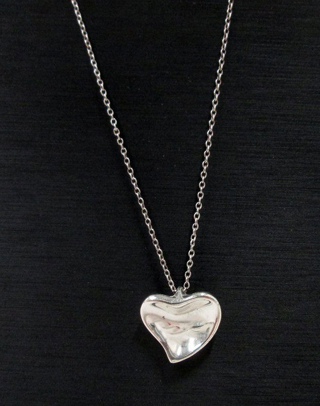 TIFFANY & CO. ELSA PERETTI STERLING HEART NECKLACE: Sterling silver closed heart necklace. Heart & chain are both marked Peretti Tiffany & Co 925. Chain approximately 17."