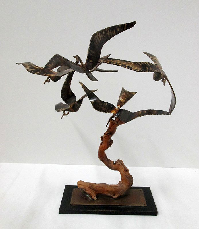 SIGNED MID CENTURY METAL BIRD SCULPTURE: Five flying birds in a circle on wood branch. Base is signed and dated 1969. 19" tall, birds approximately 17" wide. Similar to Curtis Jere.