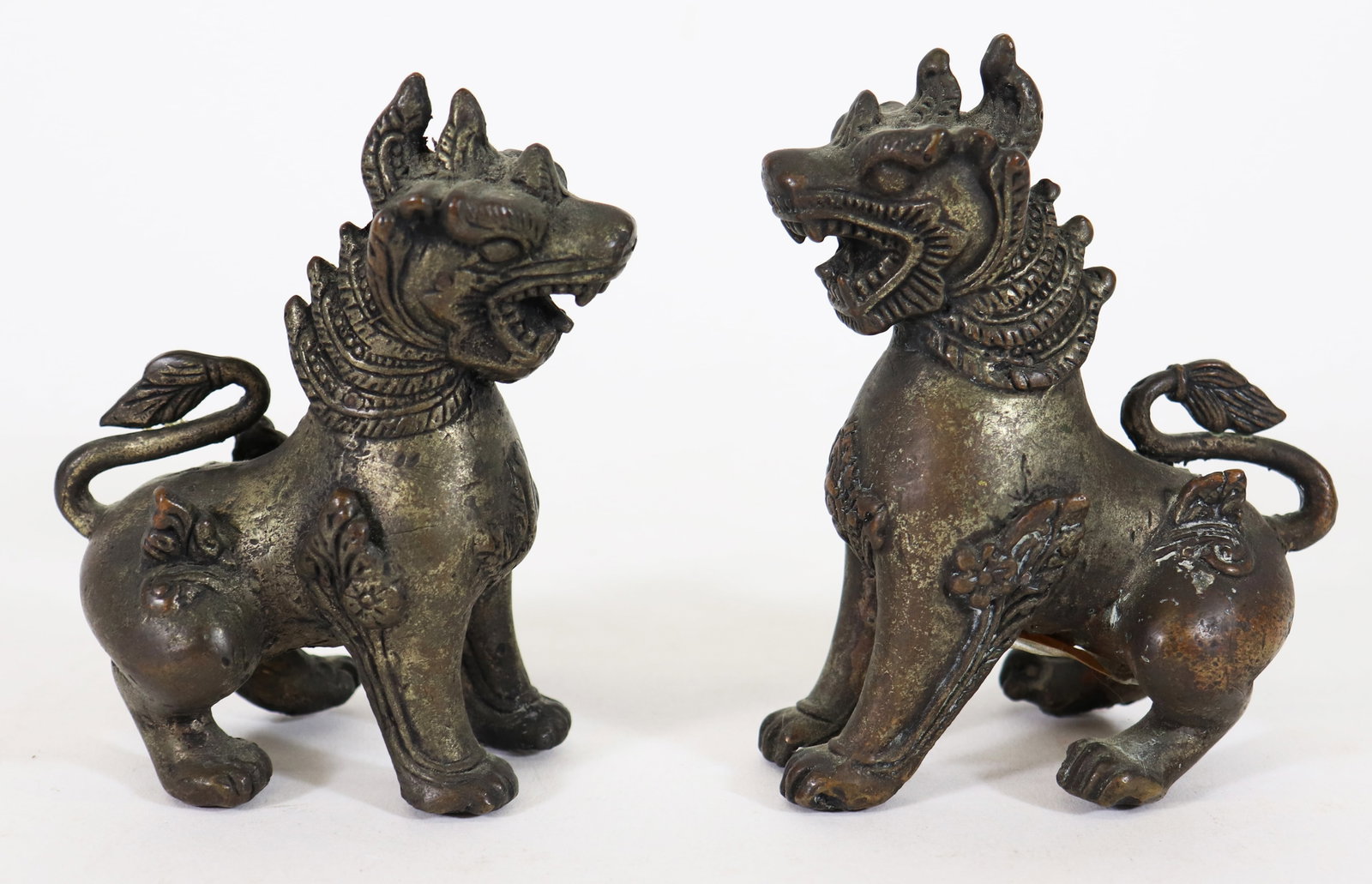 (2) ASIAN BRONZE FOO DOGS: Pair of Asian bronze metal Burmese style food dogs. Each measures approximately 5" x 2" x 3".