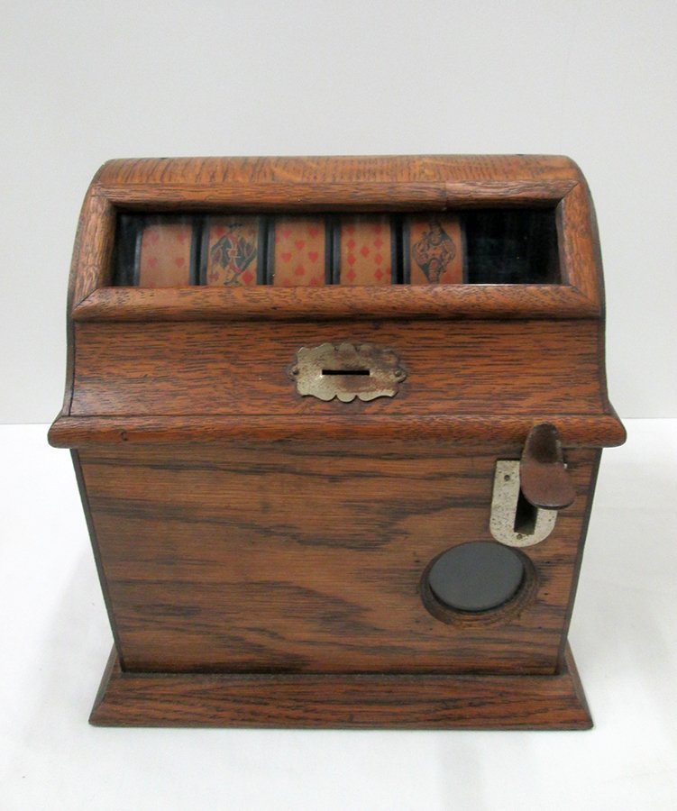 MILLS NOVELTY POKER AMUSEMENT MACHINE: Early 20th century coin operated wood poker amusement machine. Machine is working and includes keys to lock back drawer. Measures 11 1/4" tall 11" wide 9 1/4" deep.