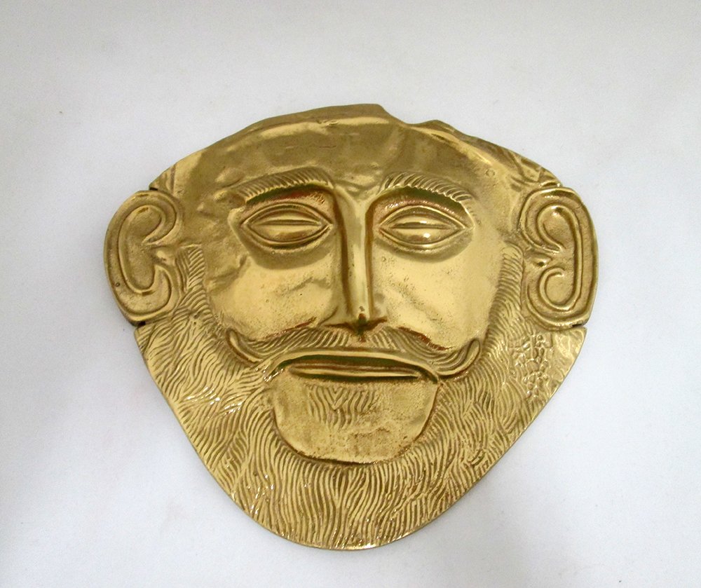 BRASS FACE PLAQUE: Decorative brass face with hook for hanging. 9" wide 8 1/2" tall.