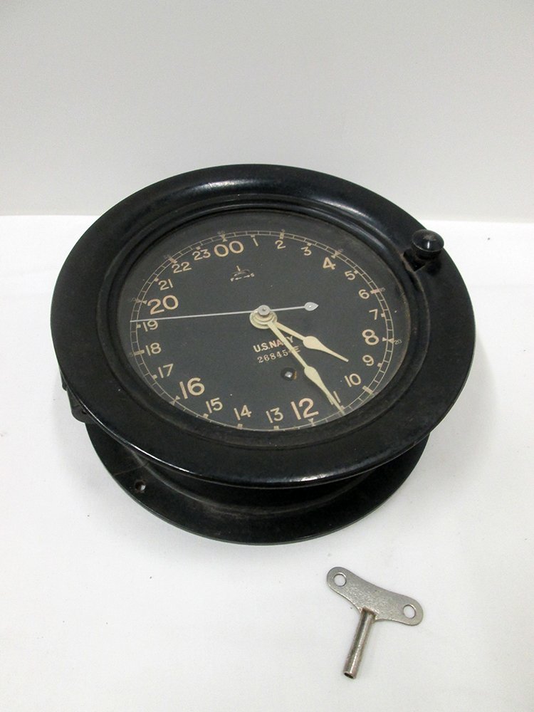SETH THOMAS US NAVY SHIPS CLOCK: Vintage Seth Thomas black U.S. Navy ship's clock. Clock is working, includes key, and measures 7 3/4" wide. Circa 1940.