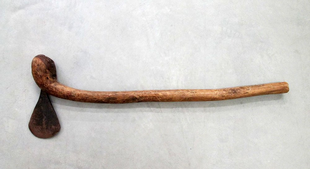 AFRICAN PRIMITIVE TRIBAL KNOBKERRIE CLUB WITH AXE: Primitive tribal weapon. Carved wood handle with a forged steel axe. Measures 28" long.
