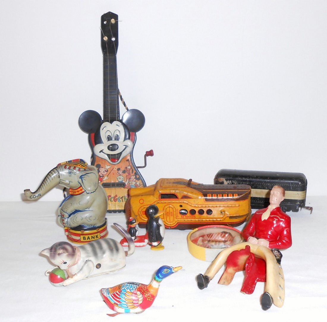 VINTAGE TIN WIND UP TOYS: Wine up cat with ball from Japan, Marx tin trains, Mickey guitar, Alps Duck, J Chein Elephant, Cowboy, and more.