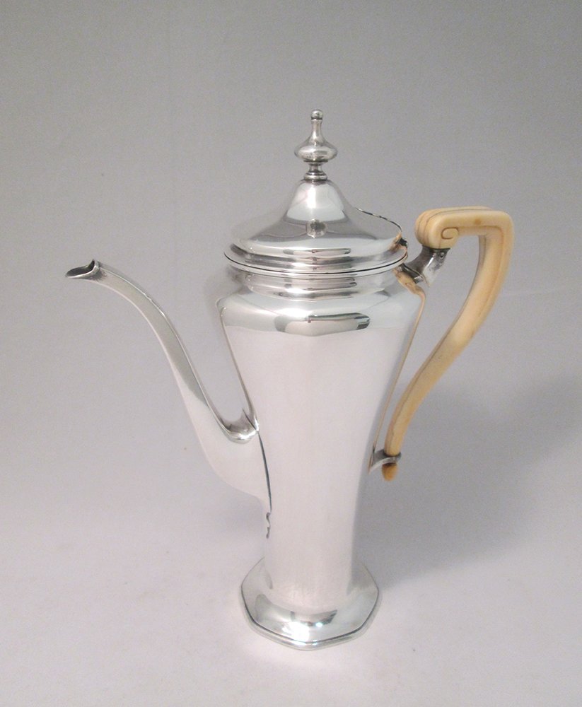 TIFFANY MAKERS STERLING SILVER COFFEE POT: Stunning Tiffany & Co. Makers coffee pot crafted in sterling silver with an ivory handle. Coffee pot measures 10" tall and weighs 21.21 OZT (659.8 grams).