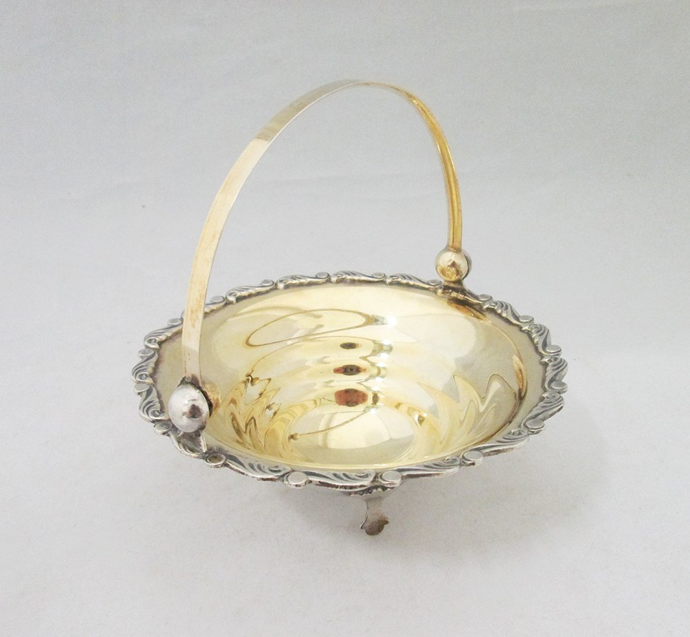 RUSSIAN SILVER HANDLED BASKET: Silver hallmarked gold washed Russian basket. Hallmarks include soviet mark, 875, and an artel or makers mark. 5 1/4" wide 5 1/2" tall with handle, weighs 5.14 OZT (160 grams).