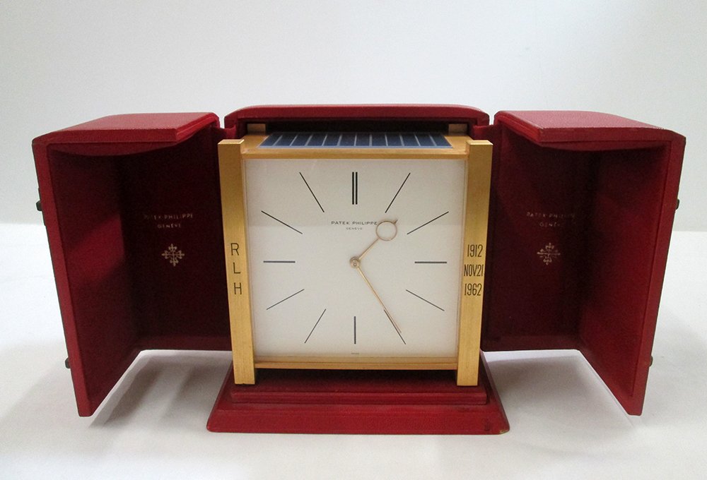 PATEK PHILIPPE SOLAR CLOCK: Rare Patek Philippe solar clock. The clock has a square brass footed case with solar panel on top and hinged back. Clock includes original box. Some monograms/inscriptions to clock. Clock measures 5 1