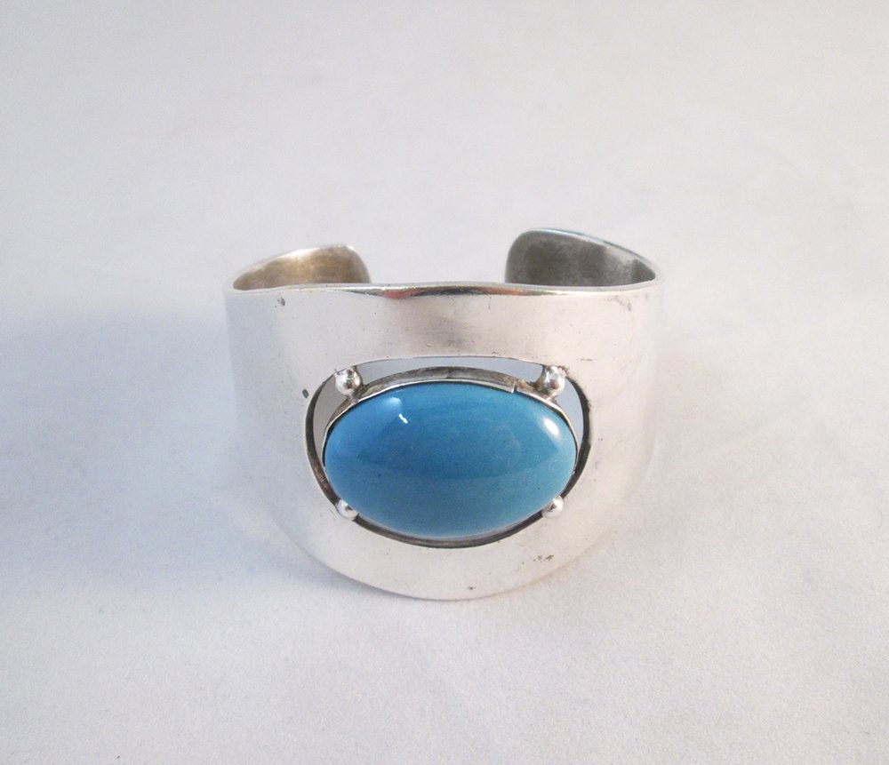 LOS CASTILLOS SILVER CUFF BRACELET: Los Castillos Taxco Mexican silver cuff bracelet with oval blue stone. 2 1/2" wide 1" wide at opening.