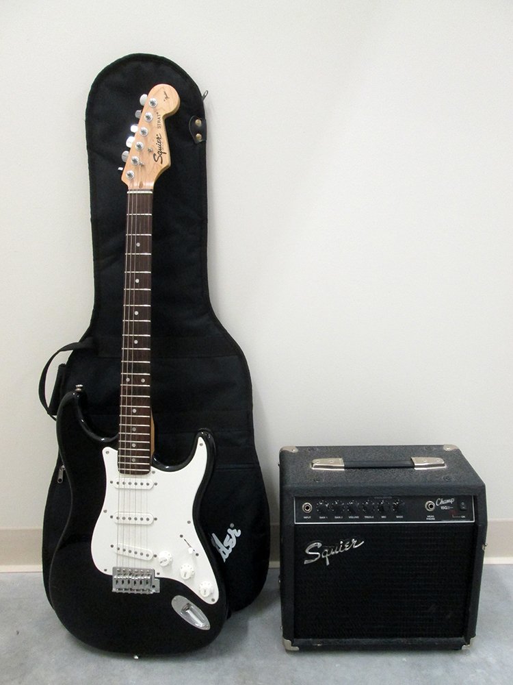 FENDER STRAT SQUIRE GUITAR AND AMP: Black & white guitar with amp.