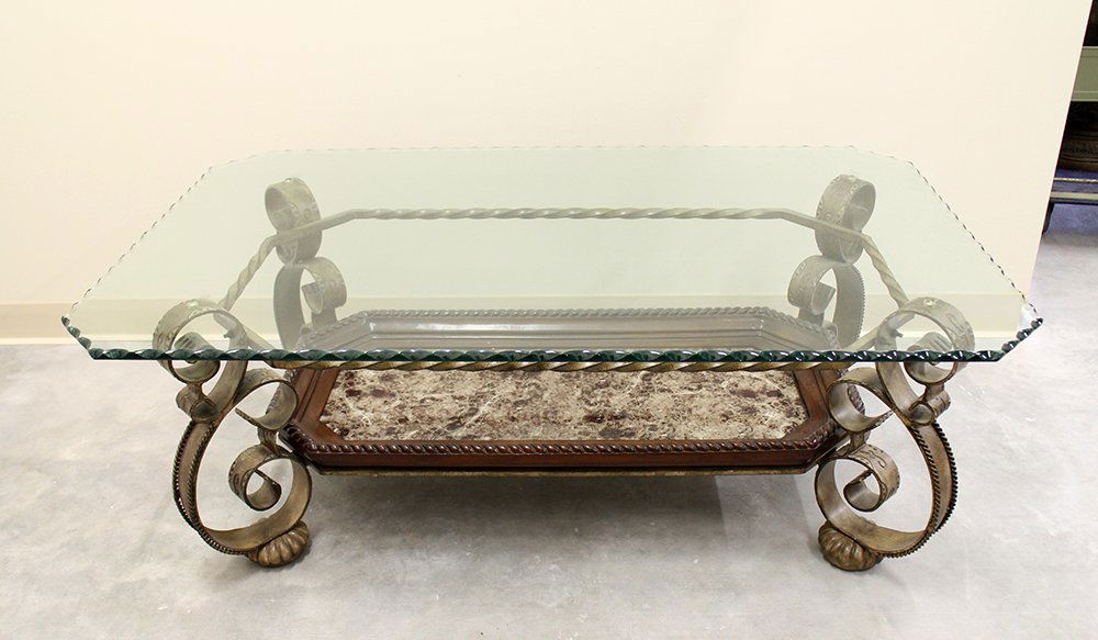 GLASS TOP COFFEE TABLE: Glass top coffee table with wavy design edges, metal with a marble style design on bottom. Measures 50" x 30" wide 18 1/2" tall.
