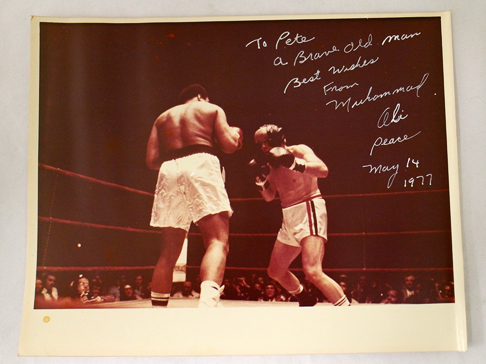 MUHAMMAD ALI SIGNED PHOTOGRAPH: Muhammad Ali autographed boxing photograph, signed and dated May 14, 1977. Measures 10" x 8"
