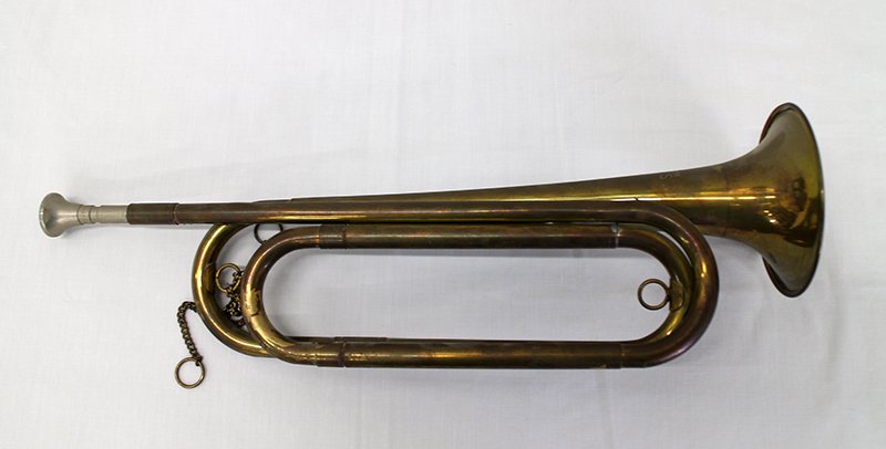 US REGULATION BUGLE: Early brass bugle with mouthpiece and chain. Measures 15" long.