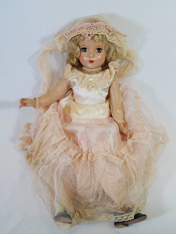 1948 MADAME ALEXANDER MAGGIE DOLL: 18" vintage Madame Alexander doll. Hard plastic body with straight legs. Blonde hair with green eyes. Head is marked Alexander. Measures 18" tall.