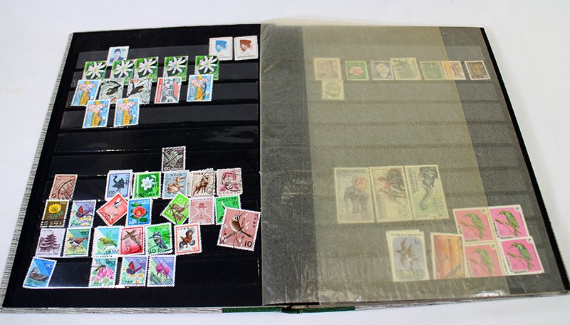 WORLD STAMP BOOK COLLECTION: Collection of stamps including China, Hong Kong, Indonesia, New Zealand, and more.