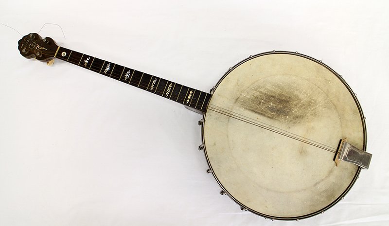 ANTIQUE YOSCO BANJO: Yosco Colossus banjo with case. Banjo has a mother of pearl neck and is made of wood, inlaid with yellow and green. Banjo is also marked Yosco Double Rim Pat'd Dec 31 18. Measures 33 1/2" long.