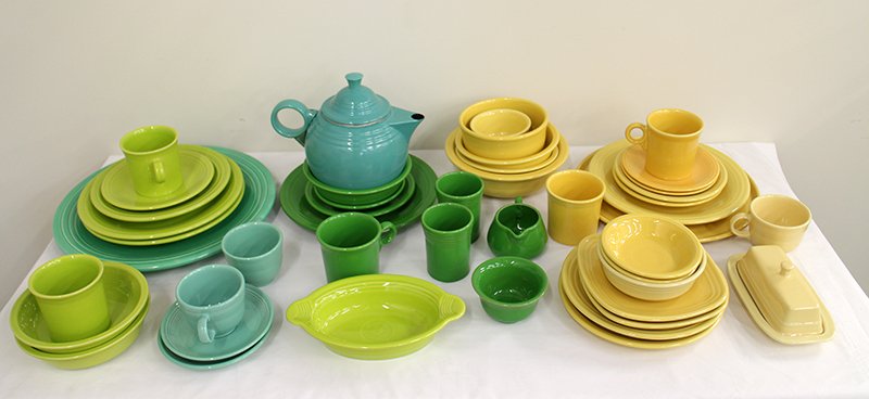 GREEN & YELLOW FIESTAWARE COLLECTION: Assorted green & yellow Fiesta ware collection including cups, bowls, plates, and more.