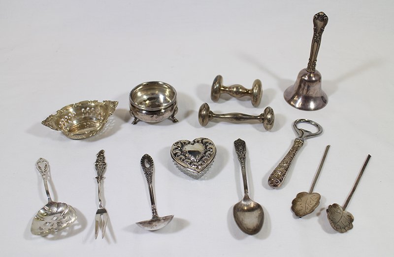 STERLING SILVER COLLECTION: Collection of sterling including bottle opener, bell, crystal heart box w/ sterling lid, nut dish, footed salt cellar, baby rattles, & more. Approximately 8 OZT.