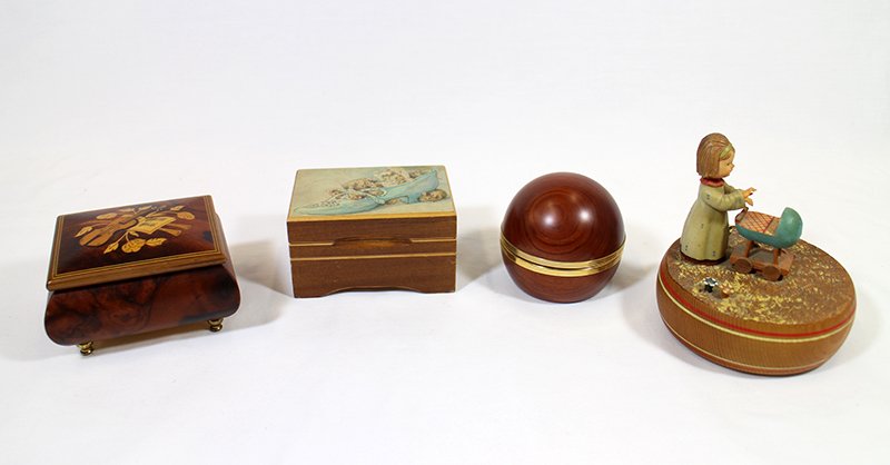 REUGE MUSIC BOXES: Four Reuge Switzerland music boxes. Feelings, My Heart Will Go On, Brahms Lullaby, As Time Goes By (with clock).