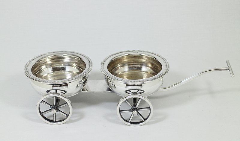 SILVERPLATE WINE COASTER WAGON: Silverplate wagon cart with pull handle for wine bottles. Moves easily for a table top to transport two bottles. 13" long 2 7/8" tall.