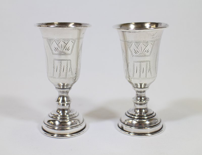 (2) RUSSIAN SILVER KIDDISH CUPS: Pair of Russian silver hallmarked kiddish cups. Both hallmarked with 1882 & 84 and unrecognizable city mark. 3 5/8" tall total weight of 3 OZT.