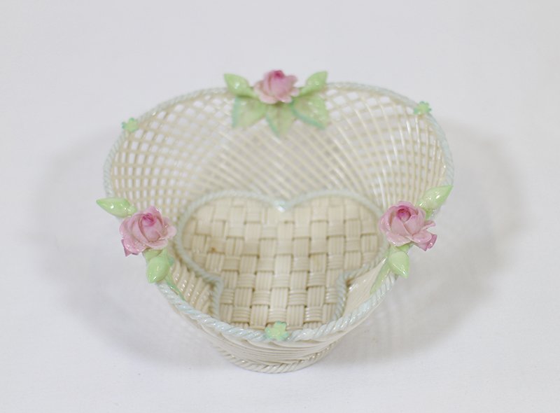 BELLEEK PORCELAIN BASKET: Belleek basket with flower and clover decoration. 2 1/4" tall 5 1/4" wide.