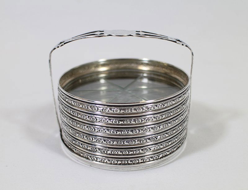WEBSTER STERLING COASTER SET: Webster six sterling & glass coasters with sterling holder. Coasters 3 1/8" wide.