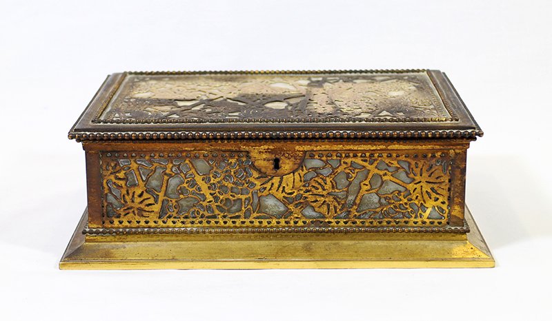 TIFFANY STUDIOS DRESSER BOX: Tiffany Studios dresser box, gilt gronze with slag glass. Marked Tiffany Studios New York 830. Back piece of slag glass has crack & chip. Measures 9 3/8" x 6 5/8" wide 3 1/8" tall.