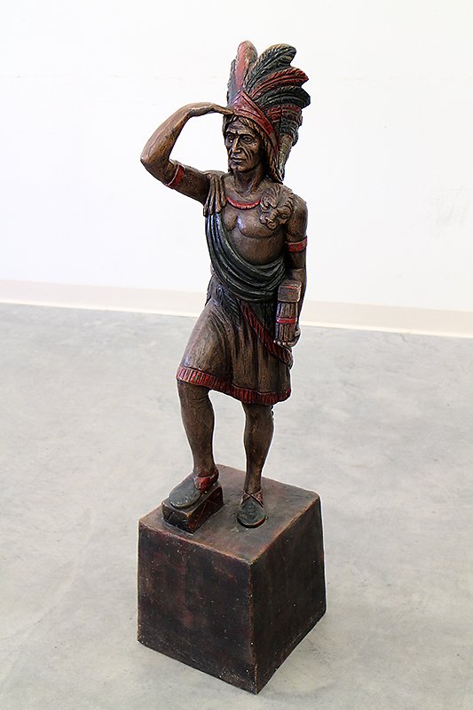 INDIAN CHIEF STATUE: Tall Native American Indian Chief saluting statue. Made of resin? Stands 4 feet tall.