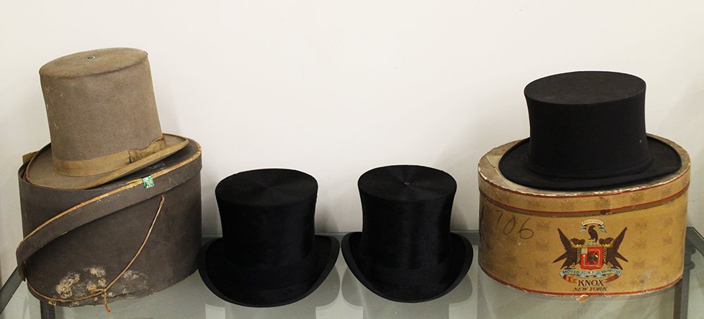 (4) ANTIQUE TOP HATS & GIBUS: 19th & 20th Century top hats to include (2) black silk or beaver hats both made by Dunlap Hatters - one marked size 7 1/8, a collapsible Gibus top hat by John David with John David box and the name Hu
