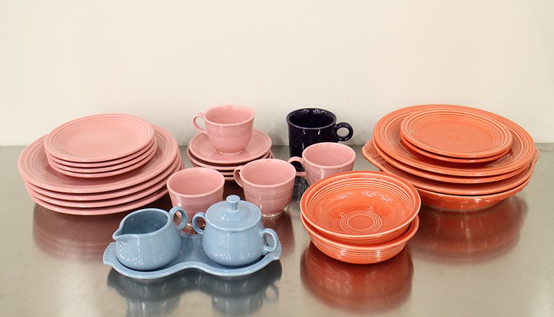 FIESTA WARE COLLECTION: Collection of assorted fiestaware including cups, plates, & more in pink, blue, red, & purple.