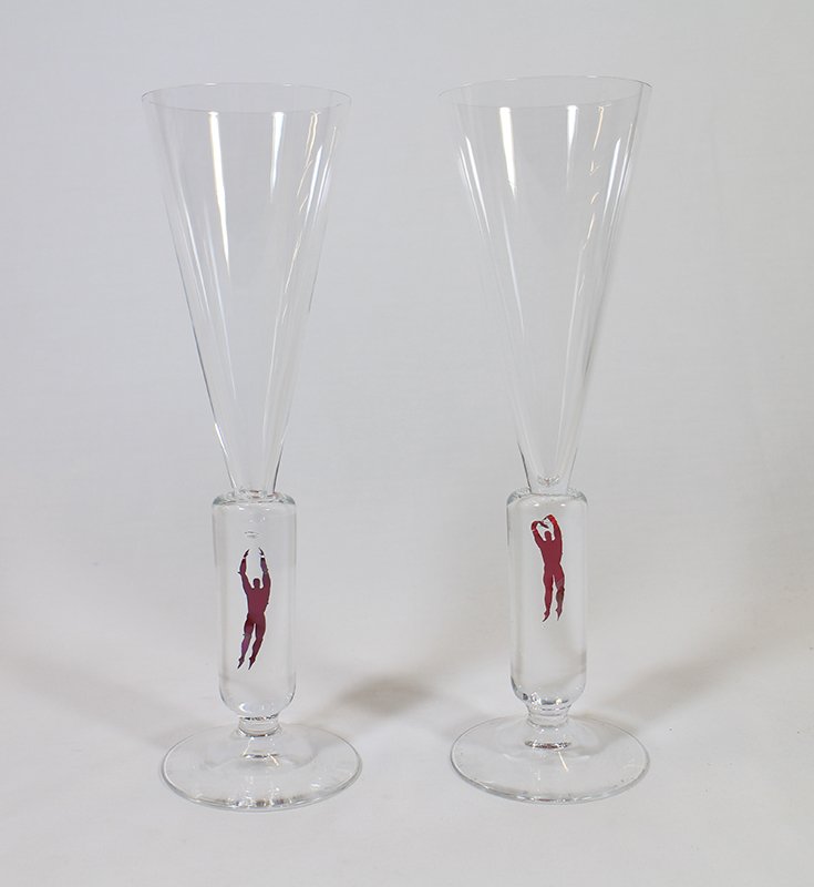(2) KOSTA BODA B. VALLIEN CHAMPAGNE FLUTES: Champagne flutes with floating man in the stem. 99836/15048 and 99836/15047 marked on bottom. 10.25"