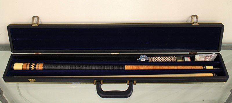 MCDERMOTT POOL CUE: Mcdermott pool cue with hard case. Cue has a great inlaid design and is marked with an M inside a shamrock. Measures a total of 58 3/4" long.