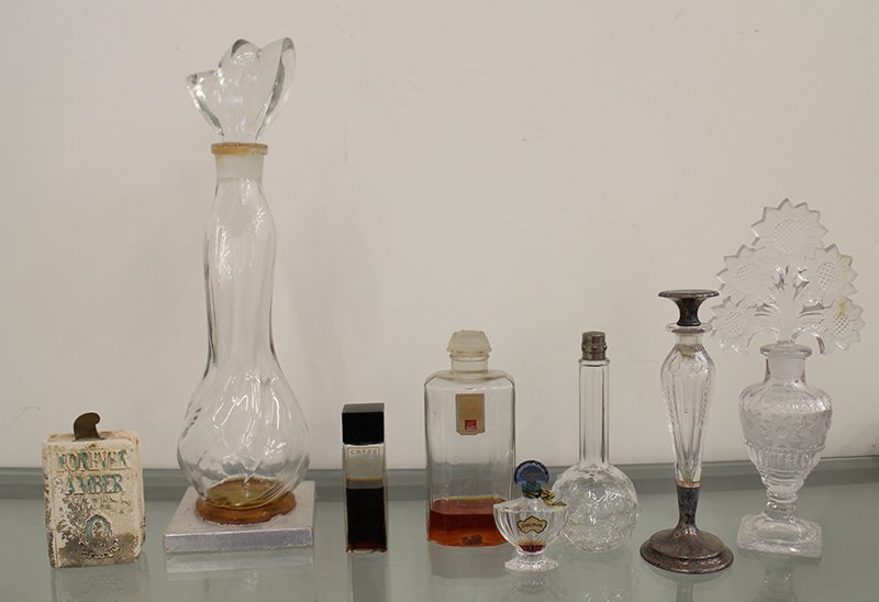 PERFUME BOTTLE COLLECTION: Vintage perfume bottles, one etched glass with sterling accents (bottom of stopper broken), Crepe de Chine, & more.